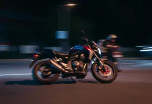 An abstract representation of a motorcycle crash scene at night.