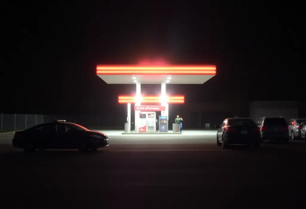 Police lights at a gas station during a nighttime incident