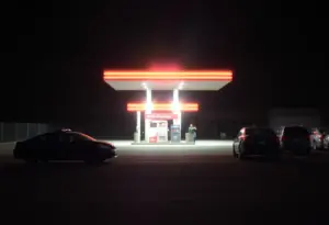 Police lights at a gas station during a nighttime incident