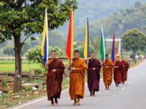 Buddhist monks walking on a rural road during their Walk for Peace