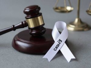 Justice emblem with gavel and child awareness ribbon
