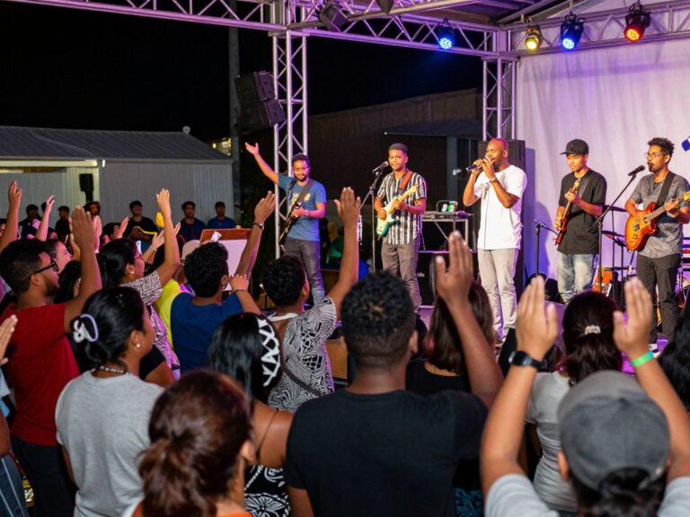 Local community gathering celebrating talent show performance.