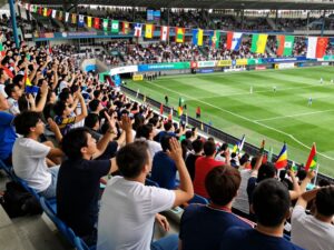 Community gathering of fans celebrating a soccer match