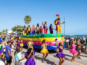 A vibrant Mardi Gras parade on the Gulf Coast with colorful floats and dancers.