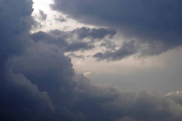 Dark storm clouds over an open landscape